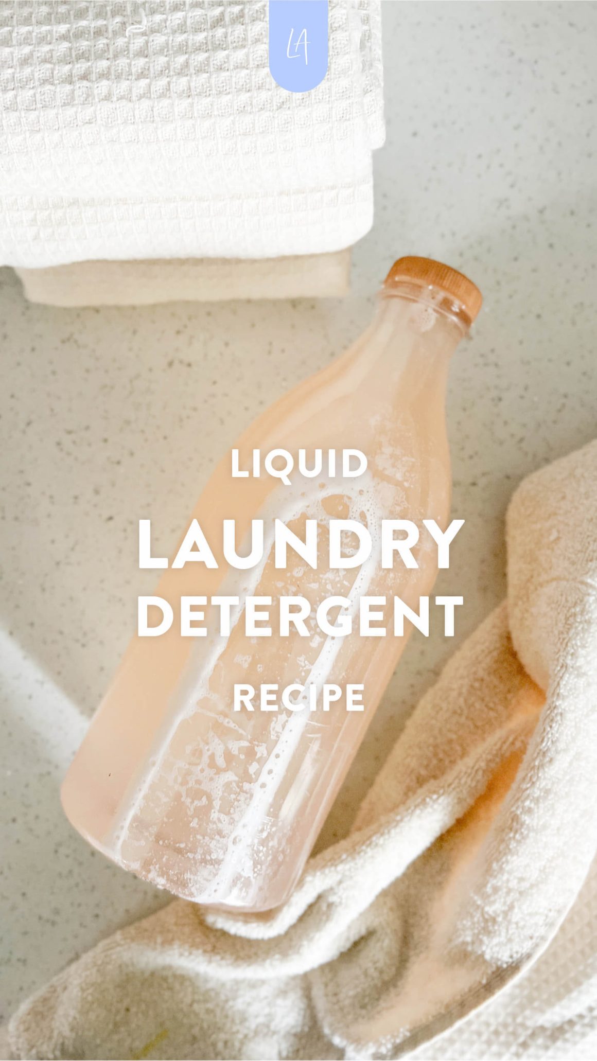 DIY Liquid laundry detergent recipe | LAurenrdaniels | Laundry detergent bottle surrounded by clean towels